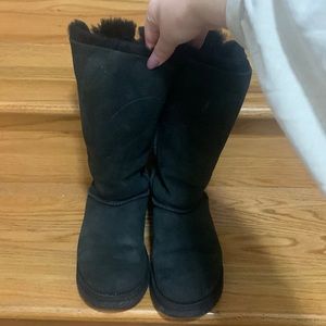 black UGG tall fuzzy boots. Cross detail in the back. Gently worn. Size 7.
